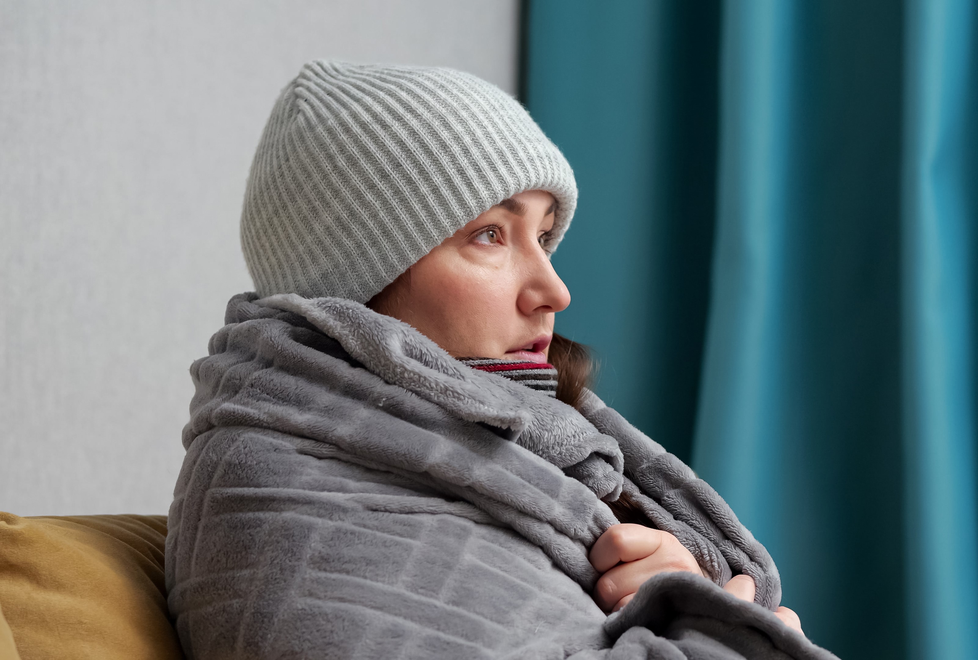 adult-woman-covers-with-blanket-tries-warm-up-home.jpg1